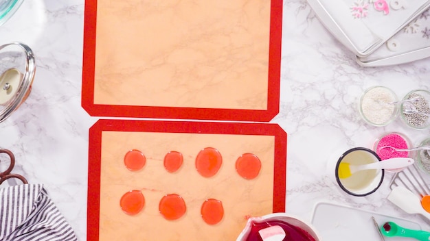 Photo flat lay. step by step. pouring caramelized sugar on a silicone baking mat to make homemade lollipops.