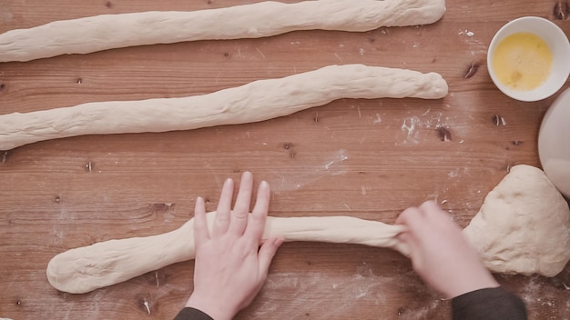 Flat lay. Step by step. Rolling dough into even parts to bake challah bread.