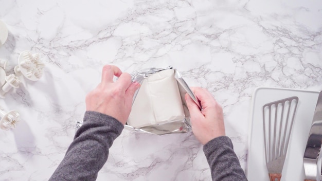 Flat lay. Step by step. Rolling our white fondant on a marble counter.