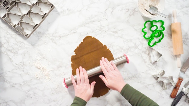 Flat lay. Step by step. Rolling out gingerbread cookie dough to bake Christmas cookies.