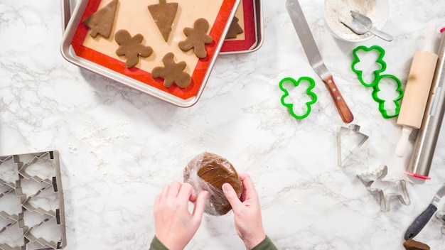 Flat lay. Step by step. Rolling out gingerbread cookie dough to bake Christmas cookies.