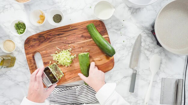 Flat lay. Step by step. Shredding organic zucchini to make zucchini cakes.