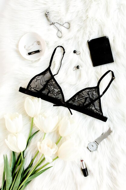 Photo flat lay stylish sexy black lingerie accessories on a white background top view