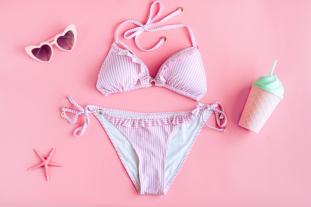 Flat lay of summer items with colorful bikini and sunglasses