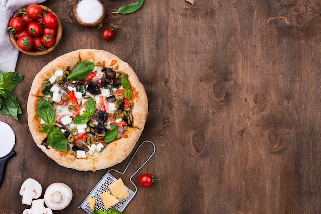 Flat lay tasty pizza with vegetables