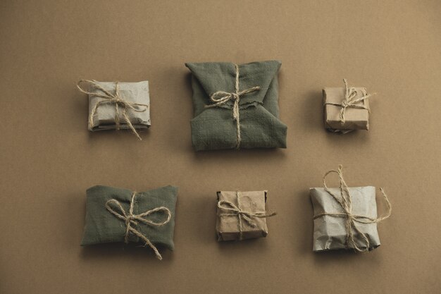 flat lay textile and kraft paper gift boxes on brown