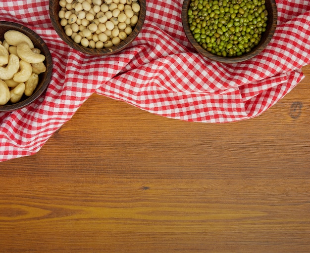 Flat lay, top view assorted beans on wooden table with copy space