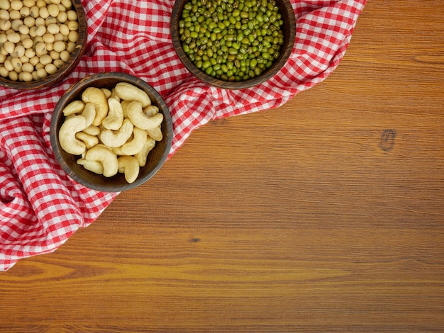 Flat lay, top view assorted beans on wooden table with copy space