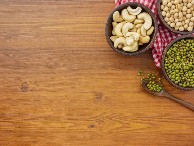 Flat lay, top view assorted beans on wooden table with copy space