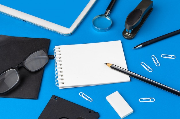 Flat lay, top view of blue office table desk, Workspace with blank note book,  office supplies