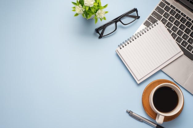 Flat lay top view image of working space ready working equipment  pastel blue color background working desk concept.