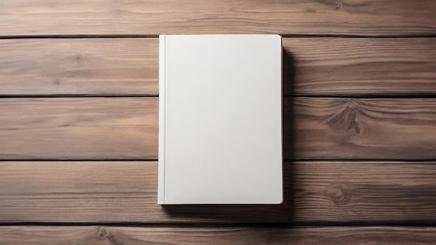 Flat lay top view mockup of plain white hard cover book on wooden background