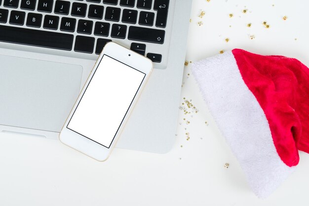 Flat lay, top view office table desk. Christmas workspace with laptop and phone on white background