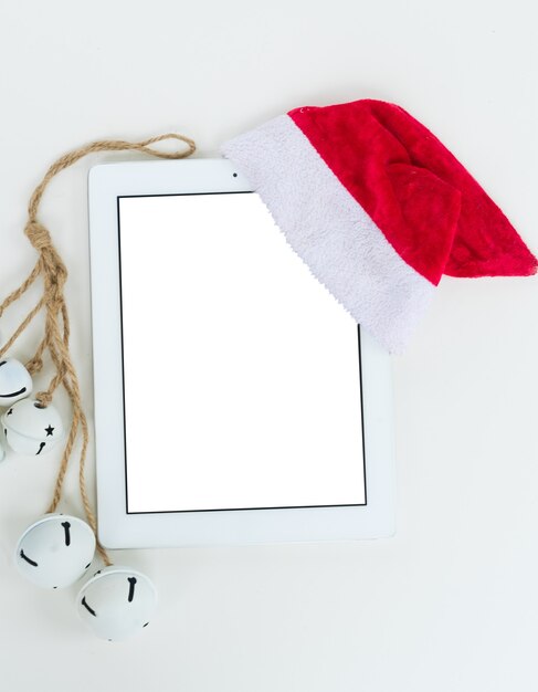 Flat lay, top view office table desk. Christmas workspace with tablet and christmas decorations