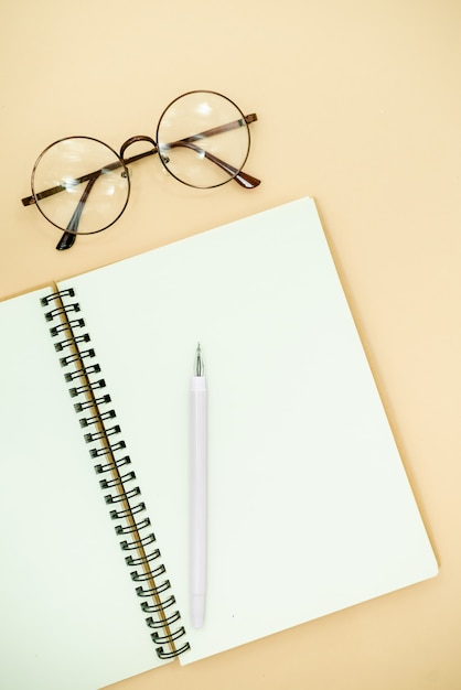  Flat Lay top view Photo of pencil, glasses and notepad  