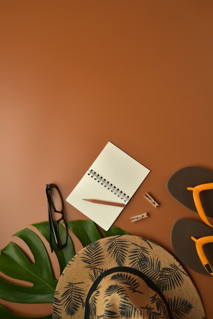 Flat lay, top view workspace on brown background with copy space