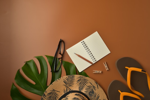 Flat lay, top view workspace on brown background with copy space.