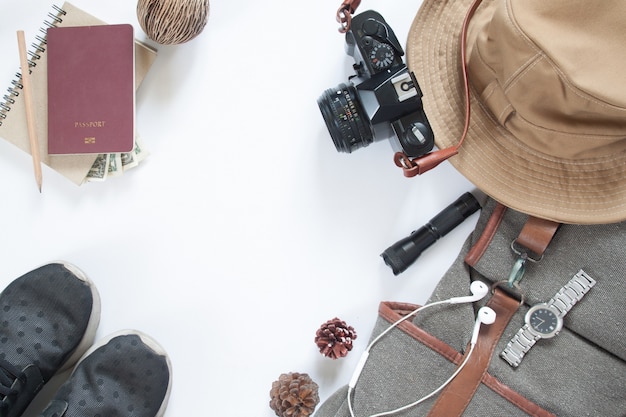Flat lay of travel accessories with camera and passport isolated on white background