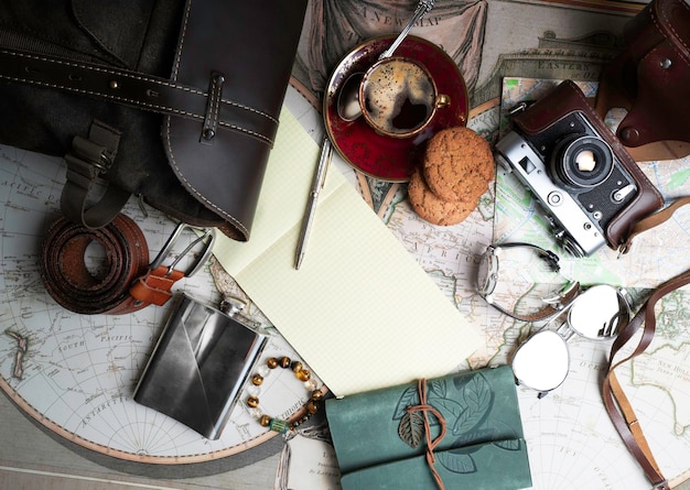 Photo flat lay of travel things on the old map