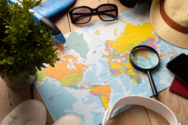 flat lay traveler accessories on map camera glasses digital devices