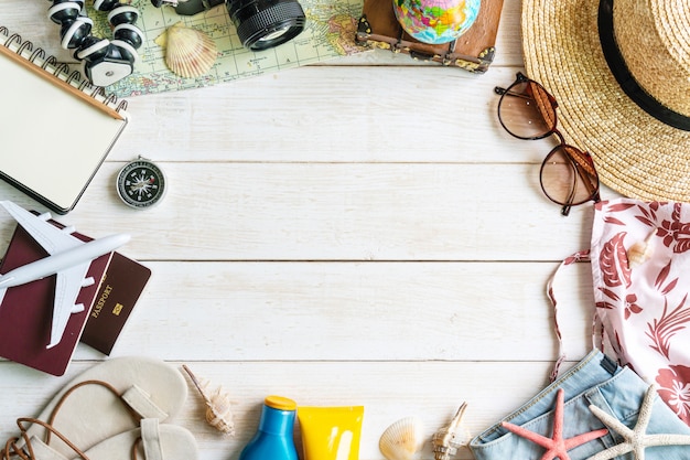 Flat lay traveler accessories  on white wooden table. Top view travel or vacation concept.