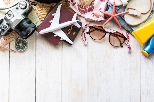 Flat lay traveler accessories  on white wooden table. Top view travel or vacation concept.