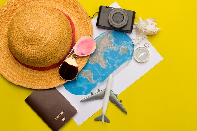 Flat lay traveler accessories on yellow background with blank space for text. Summer backg