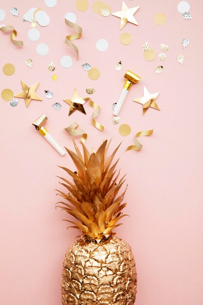 Flat lay tropical pineapple and confetti party celebration background