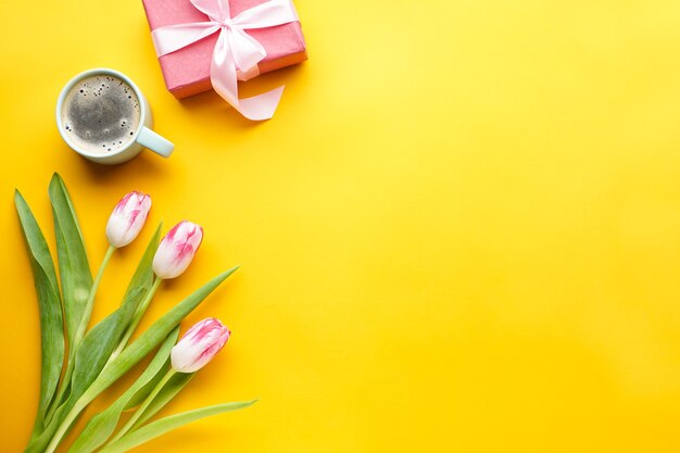 Flat lay tulips, gift box and coffee.