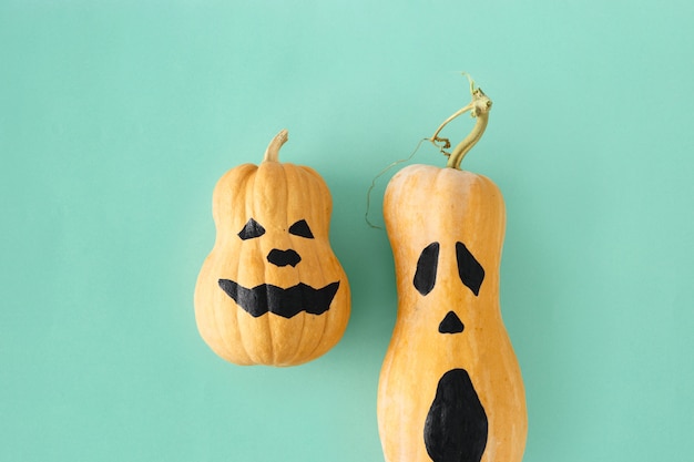 Flat lay two funny scary face Halloween pumpkins Fall autumn halloween minimal top view