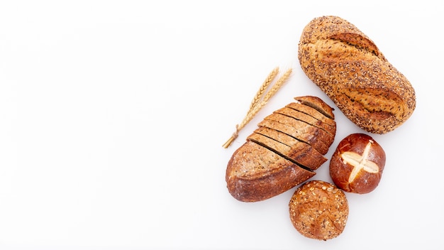 Flat lay variety of fresh baked bread and copy space