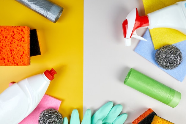 Flat lay of variety house cleaning product on color table