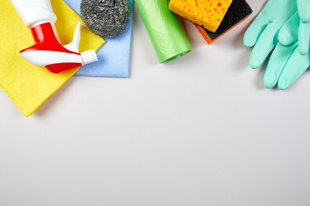 Flat lay of variety house cleaning product on grey table with copy space, cleaning set for different surfaces, Detergents service concept, Top view.