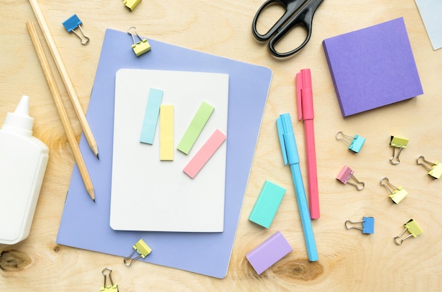 Flat lay of various stationery for school and office on wooden background top view