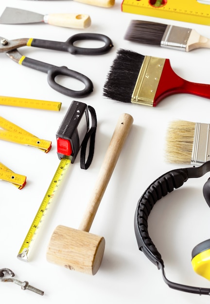 Flat lay of various technician tools isolated on white background