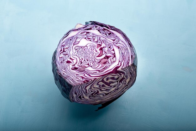 Flat lay view of purple cabbage over blue backdrop