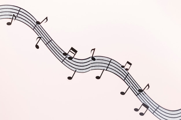 Flat lay wavy musical notes with pink background