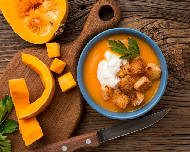 Flat lay of winter squash soup in bowl with croutons