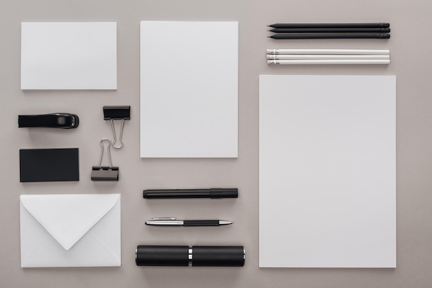 Photo flat lay with black and white stationery at workplace on grey background