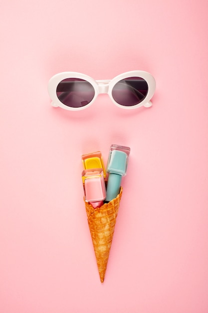 Flat lay with bright nail polish in the ice cream cone