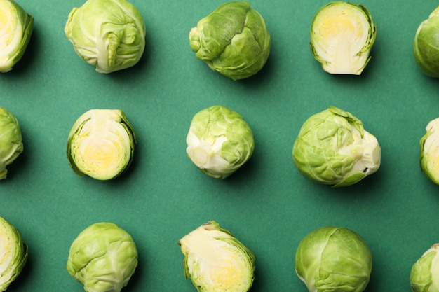 Flat lay with brussels sprout on green surface