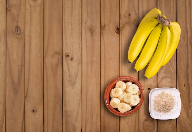 Photo flat lay with bunch of bananas and banana slices with sugar