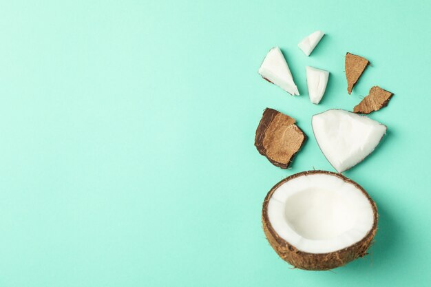 Flat lay with coconut on mint, top view