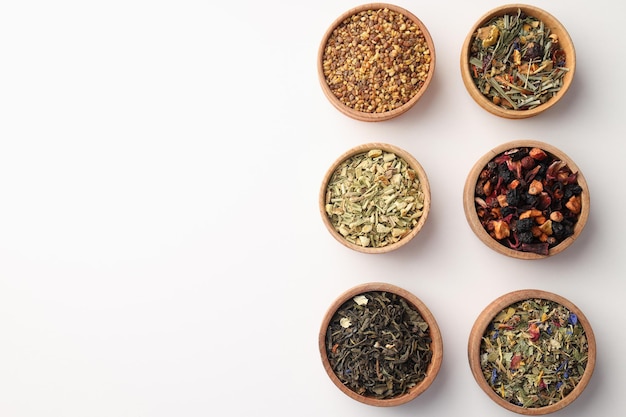 Flat lay with different types of tea on white background