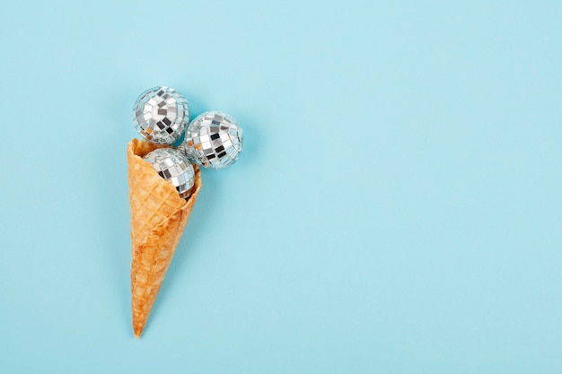 Flat lay with disco balls in the waffle cone