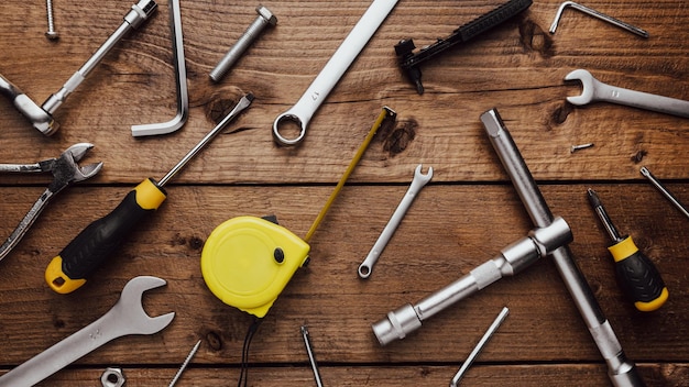 Flat lay with dyi composition of various work carpentry tools on brown wooden decks background