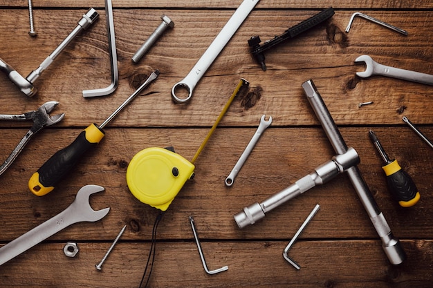 Photo flat lay with dyi composition of various work carpentry tools knolled on wooden background table