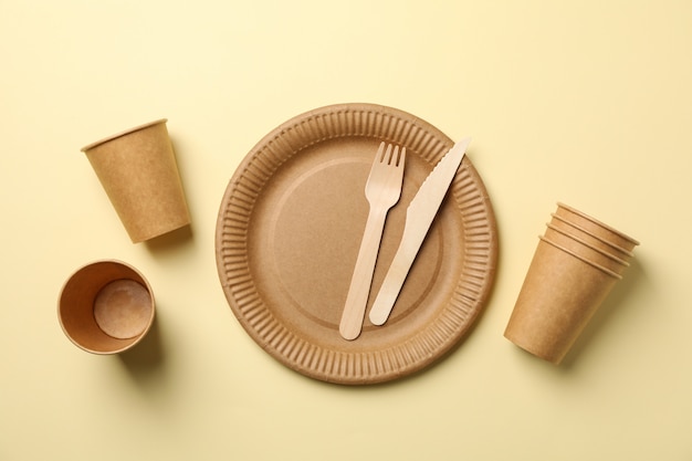 Flat lay with eco - friendly tableware on beige, space for text