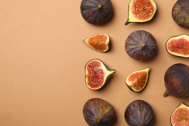 Flat lay with fig fruits on light brown