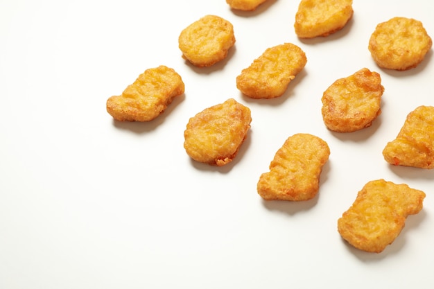 Flat lay with fried chicken nuggets on white background